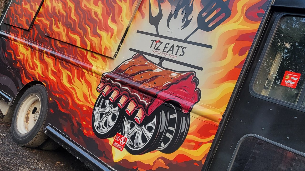 Full printed commercial food-truck wrap with bold branded graphics